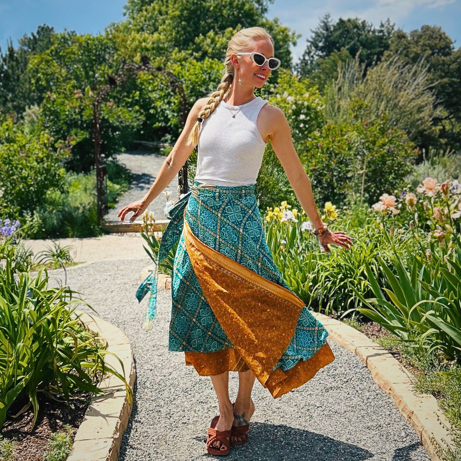 woman wearing teal and orange wrap skirt in garden