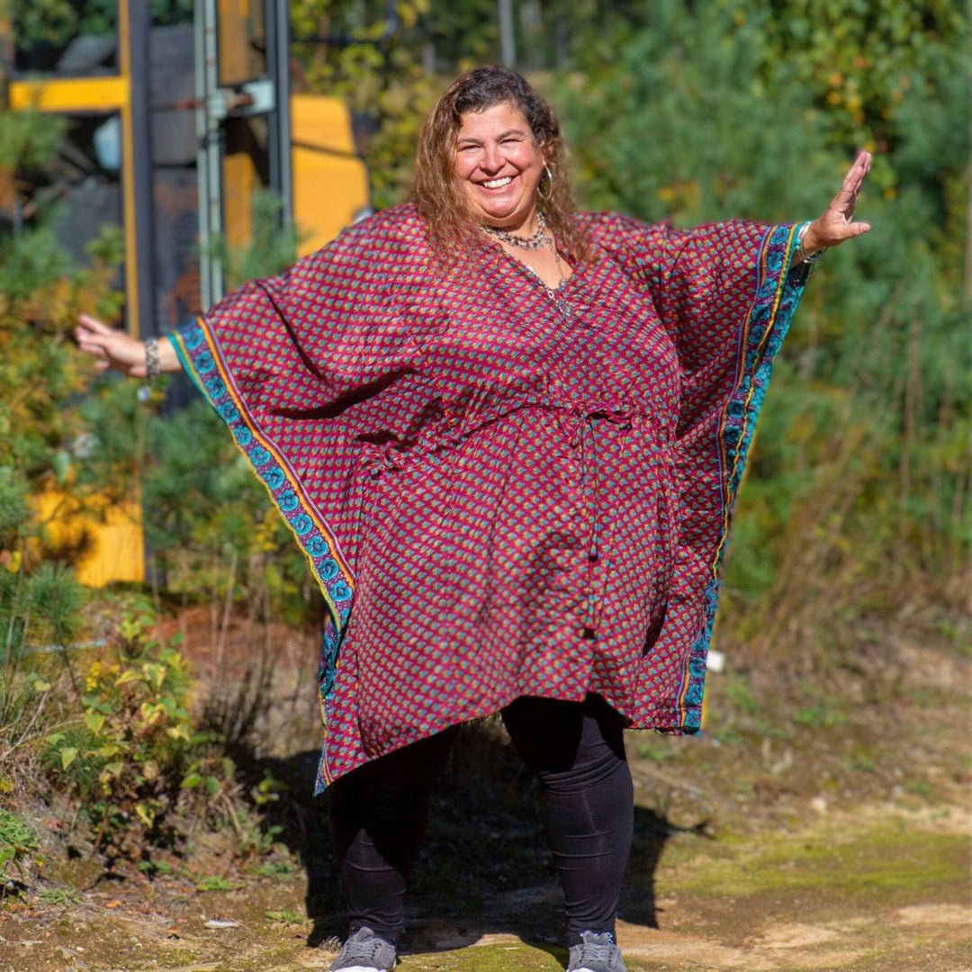 Woman standing in front of a school bus wearing a reddish aanya short kaftan