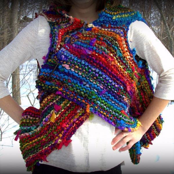 Woman wearing Adventure Cardi vest in multicolor standing in front of a snowy landscape