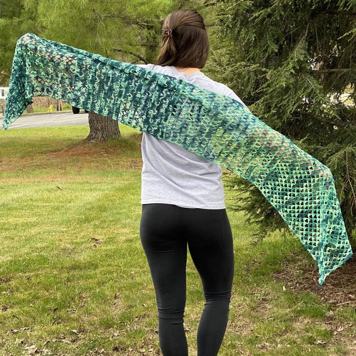 women showing off a green shawl outside