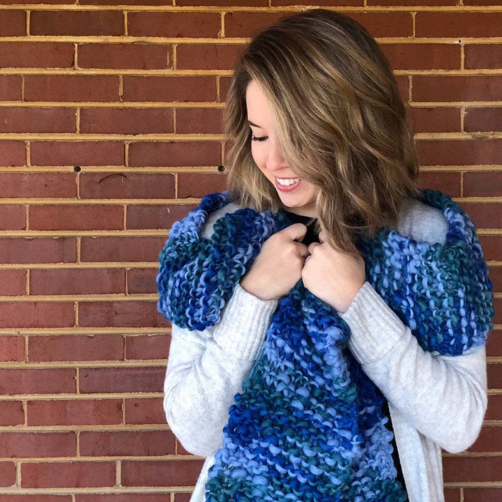 Woman wearing Blue Ridge Blanket Scarf in front of a brick wall