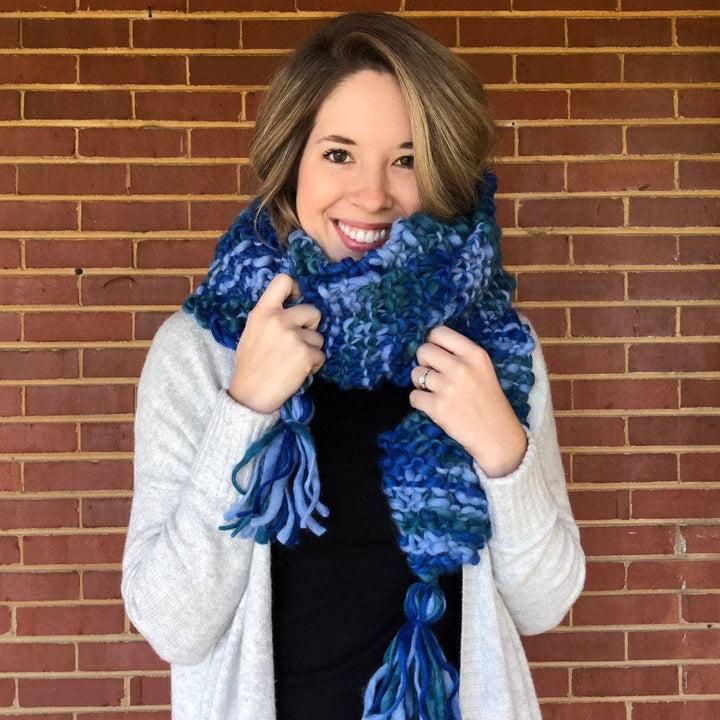 Woman wearing Blue Ridge Blanket Scarf in front of a brick wall