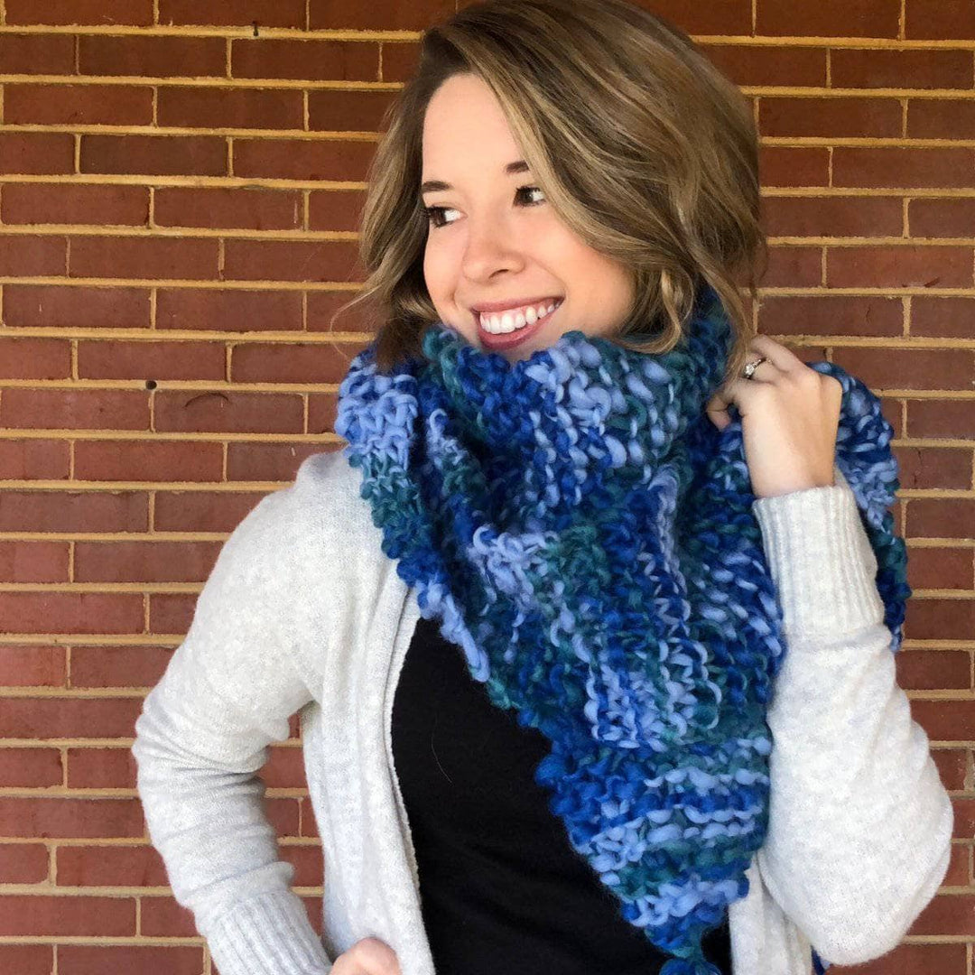 Woman wearing Blue Ridge Blanket Scarf in front of a brick wall