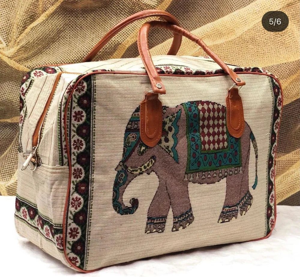 Fabric bag with embroidered elephant design and leather handles.