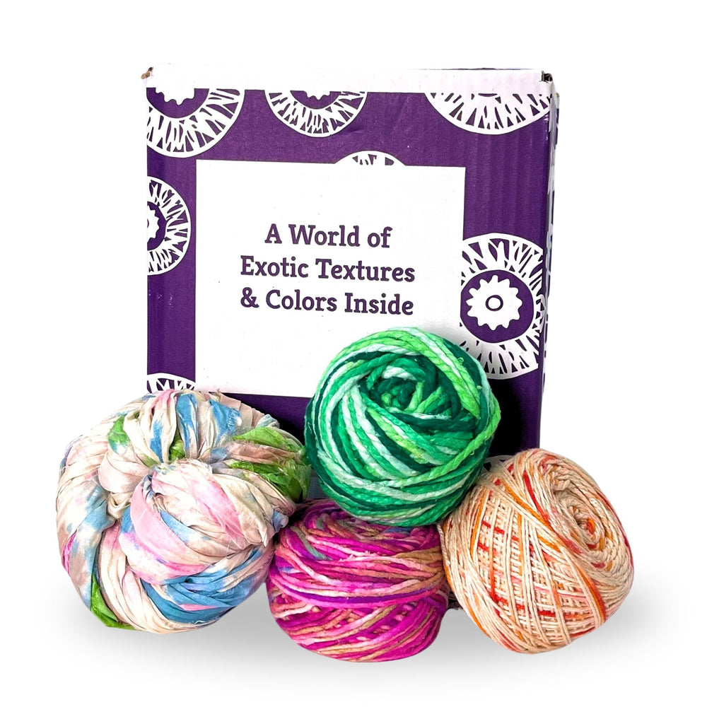 A purple box labeled "A World of Exotic Textures & Colors Inside" with colorful yarn balls