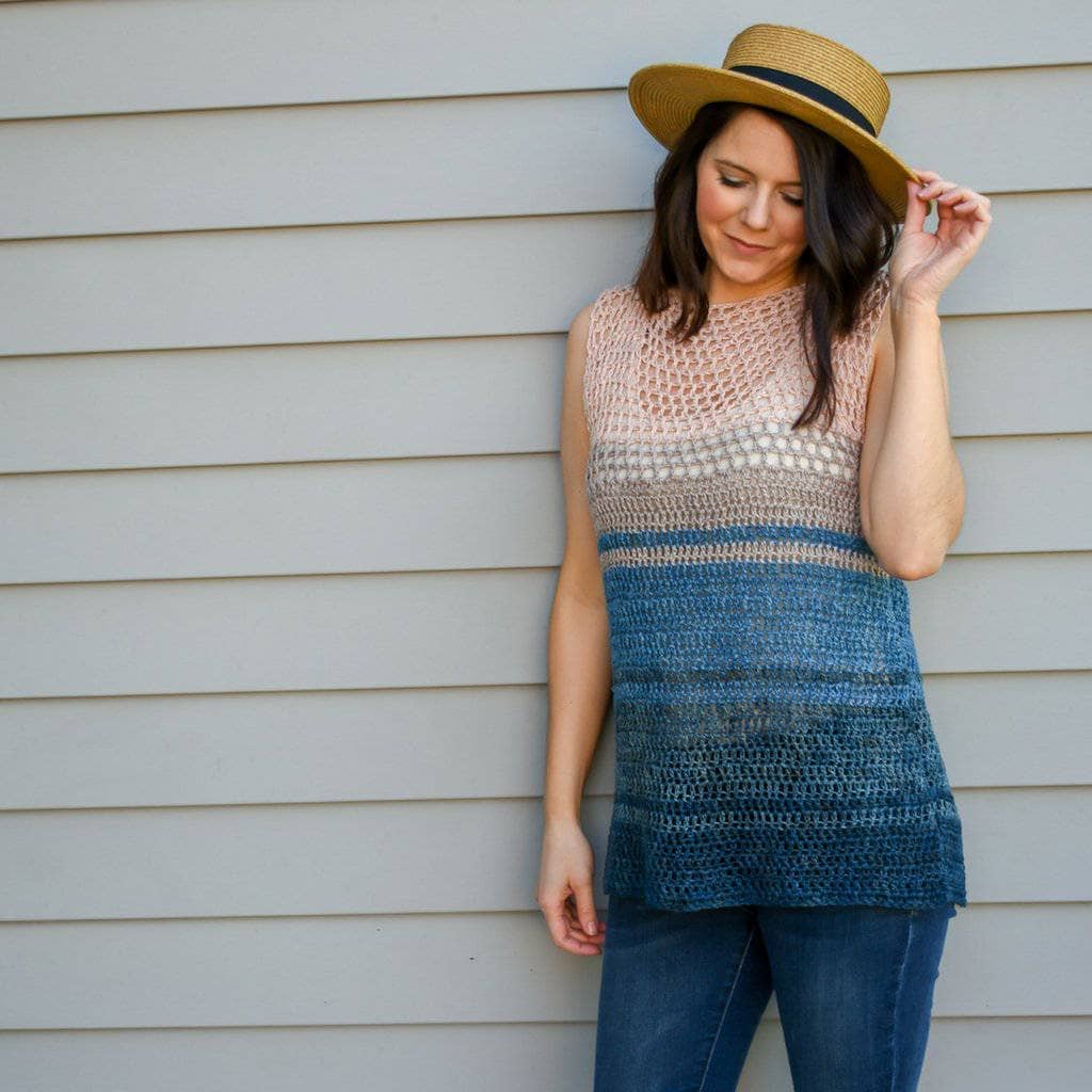 A woman wearing hat and breezy top crochet pattern ecofriendly yarn crochet knit