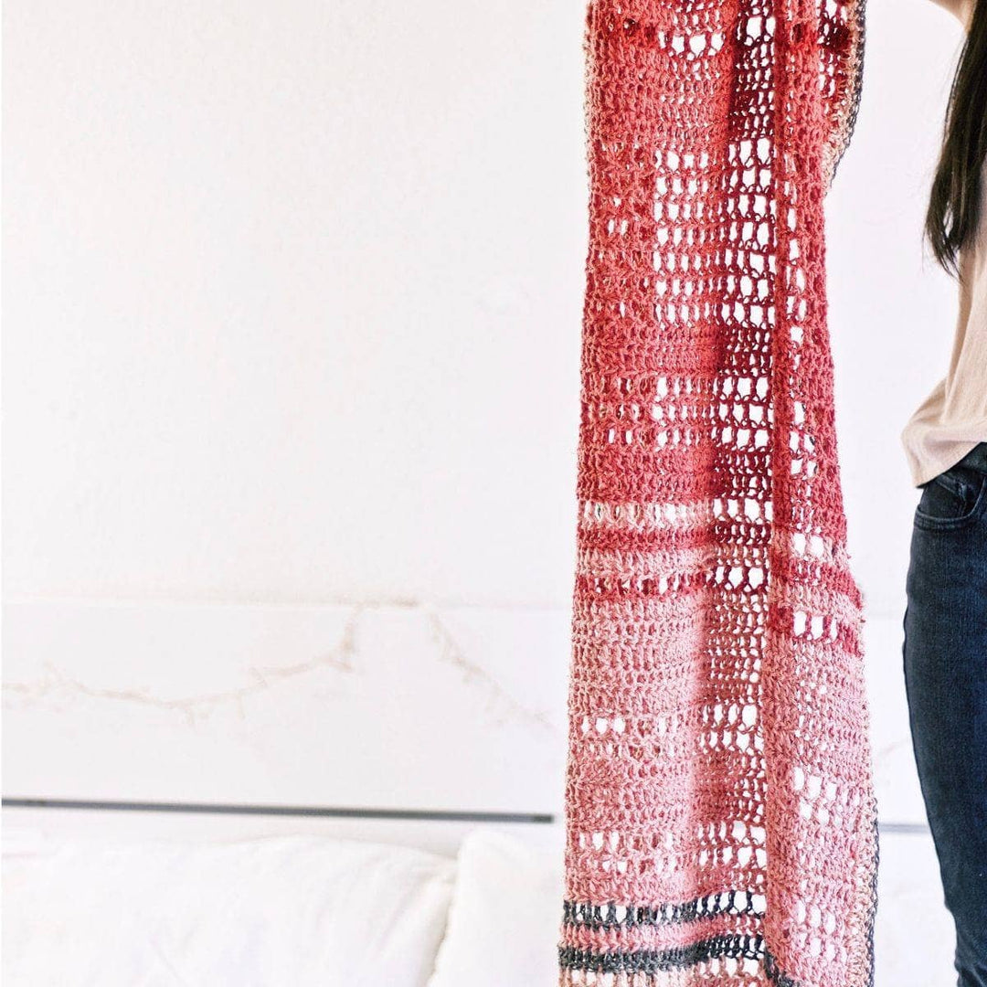 woman holding the pink En Rose Lap Blanket 