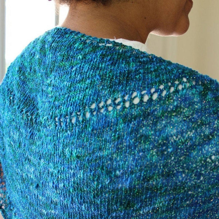 woman wearing the blue Enchantress Shawl and smiling