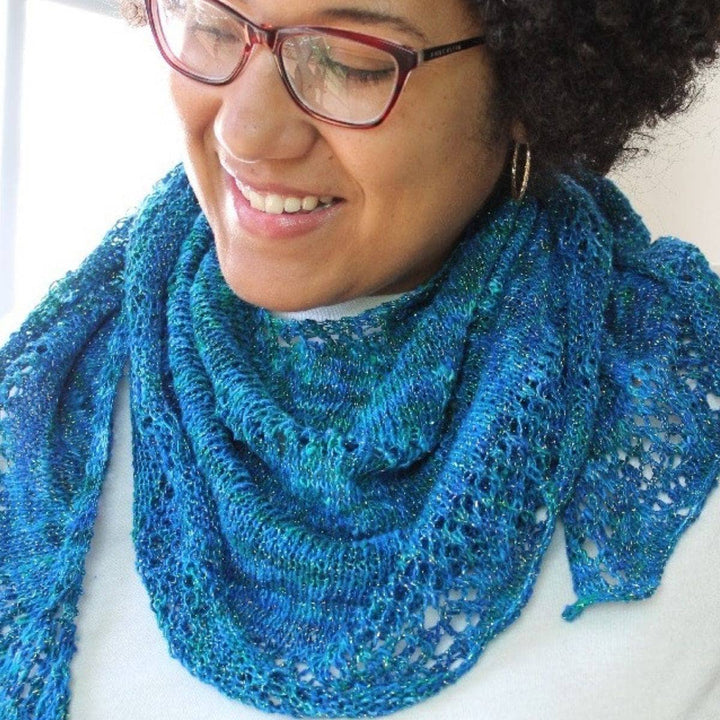 woman wearing the blue Enchantress Shawl and smiling