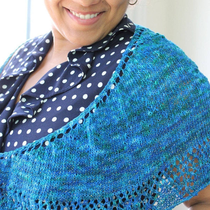 woman wearing the blue Enchantress Shawl and smiling