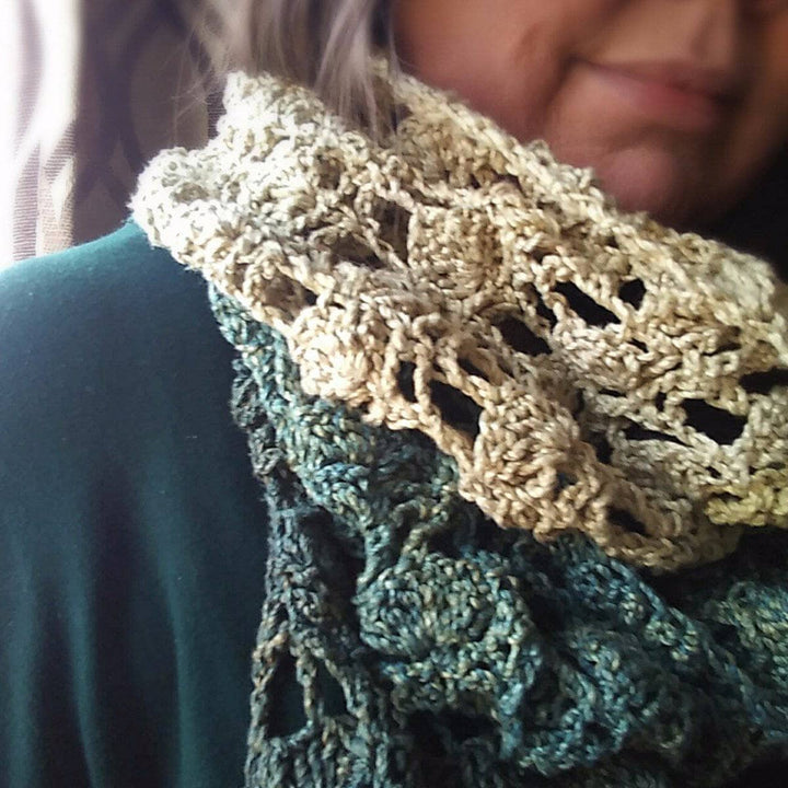 close up of green and beige crochet scarf