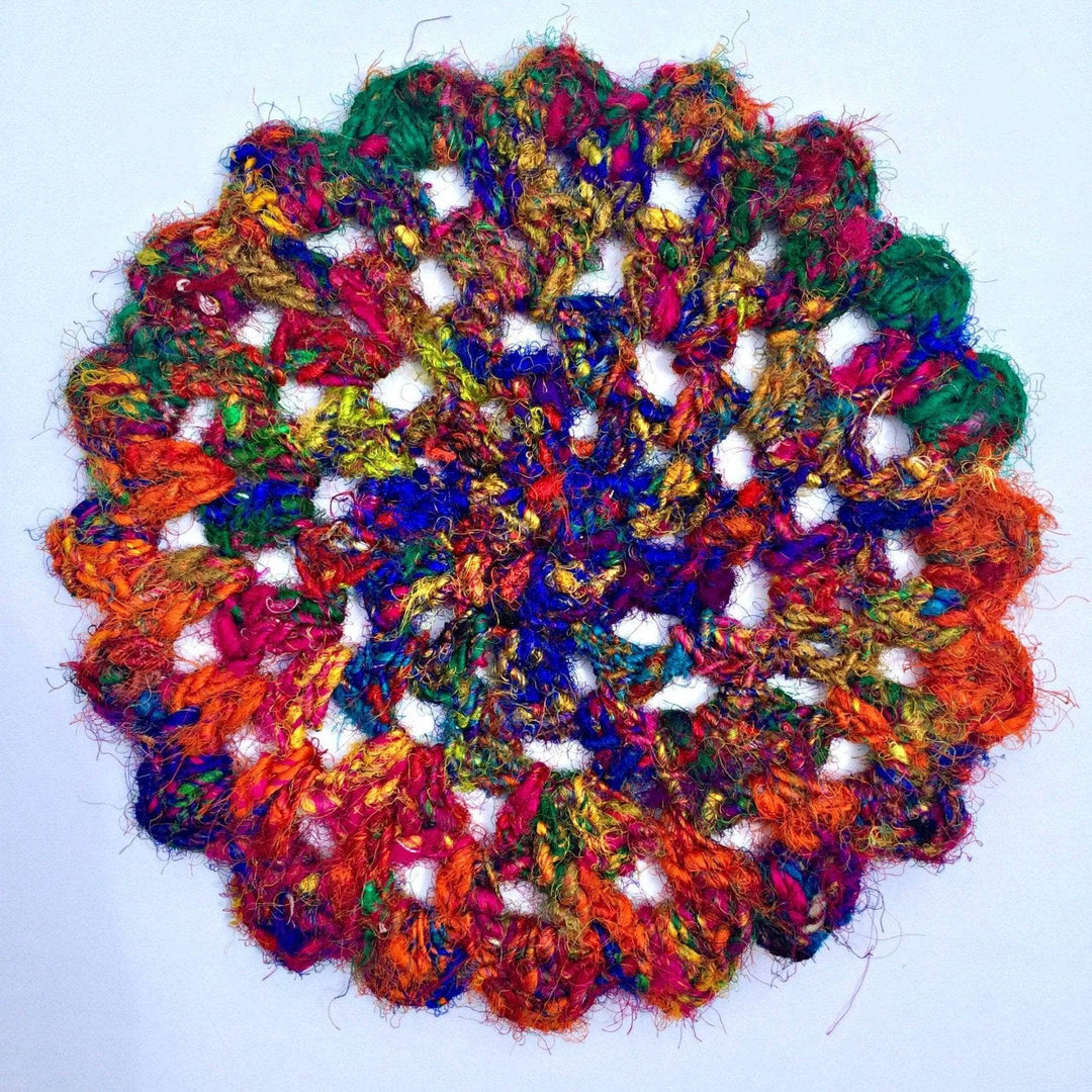 close up of colorful Doily over a white background