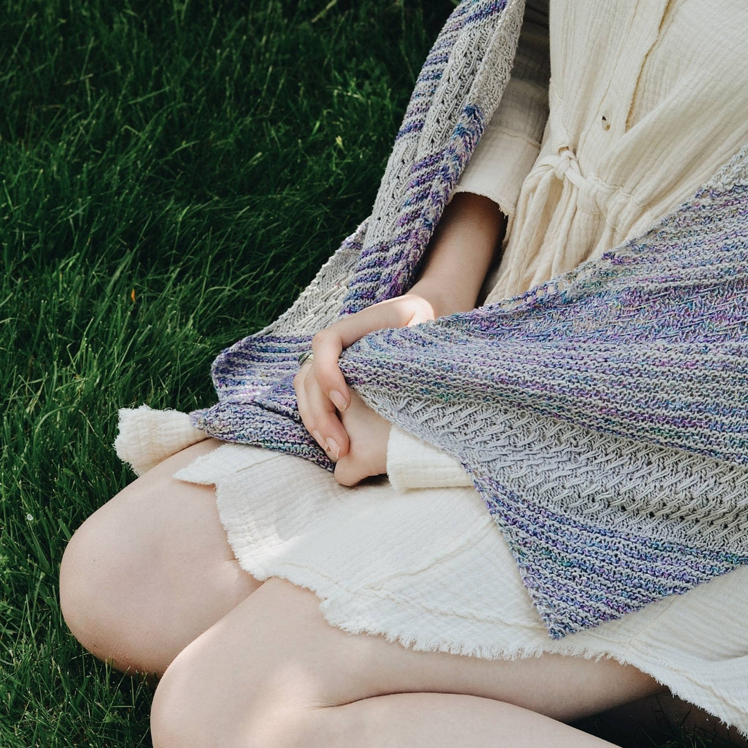 closeup of model wearing frosted forest wrap to show stitch detail.