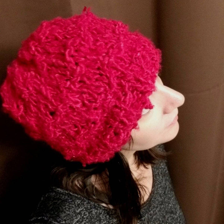 woman smiling and wearing a red Bananas Beanie