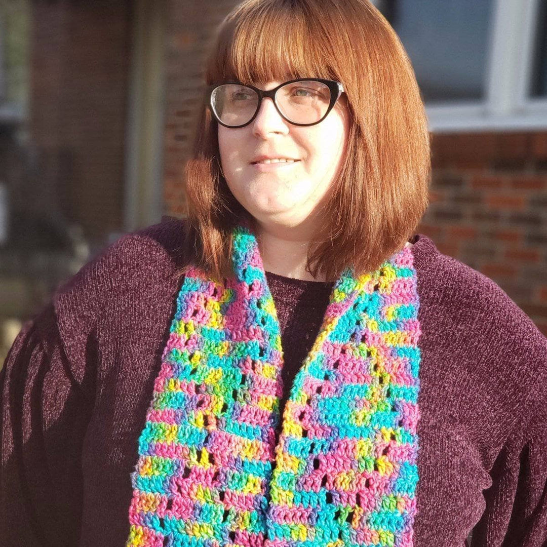 woman wearing the colorful Graduating Diamonds Crochet Scarf