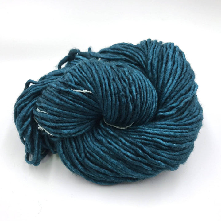 Malabrigo mecha yarn in teal feather on a white background. 