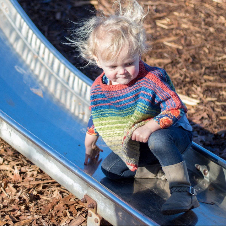 Toddler wearing a Herbal Dyed Silk Toddler Poncho outdoors