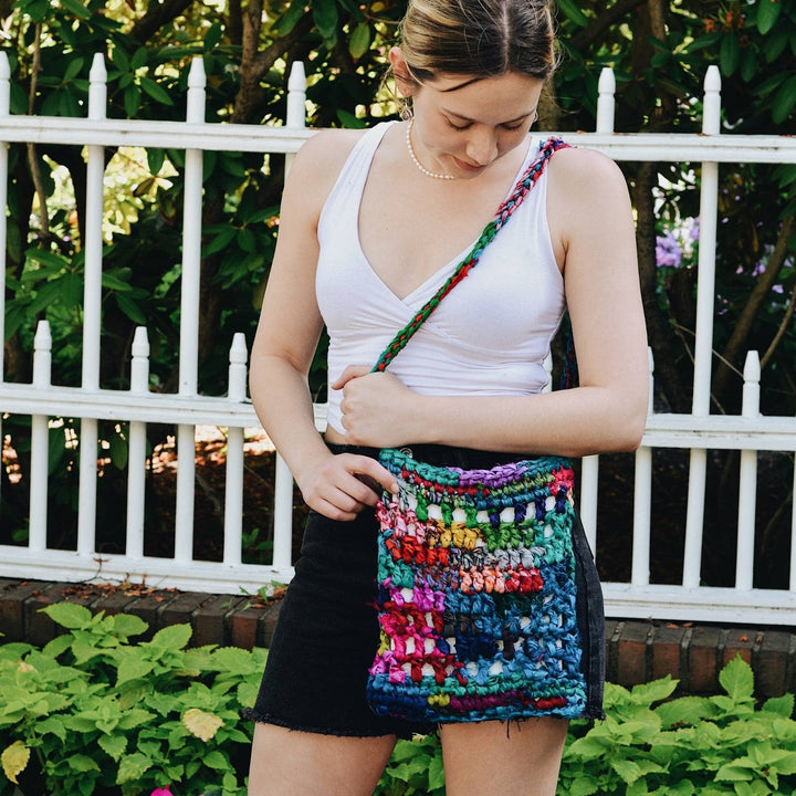 Model using sustainable recycled sari silk ribbon hidden heart purse.