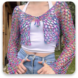 Crochet crop top in multicolored yarn. Open-weave pattern, long sleeves. Worn with jeans