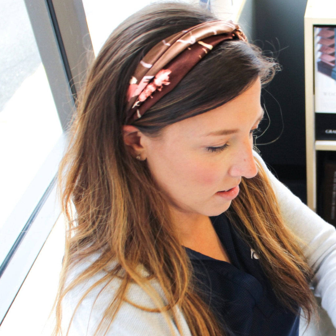 Model is smiling wearing a brown kameela knot headband in her hair.