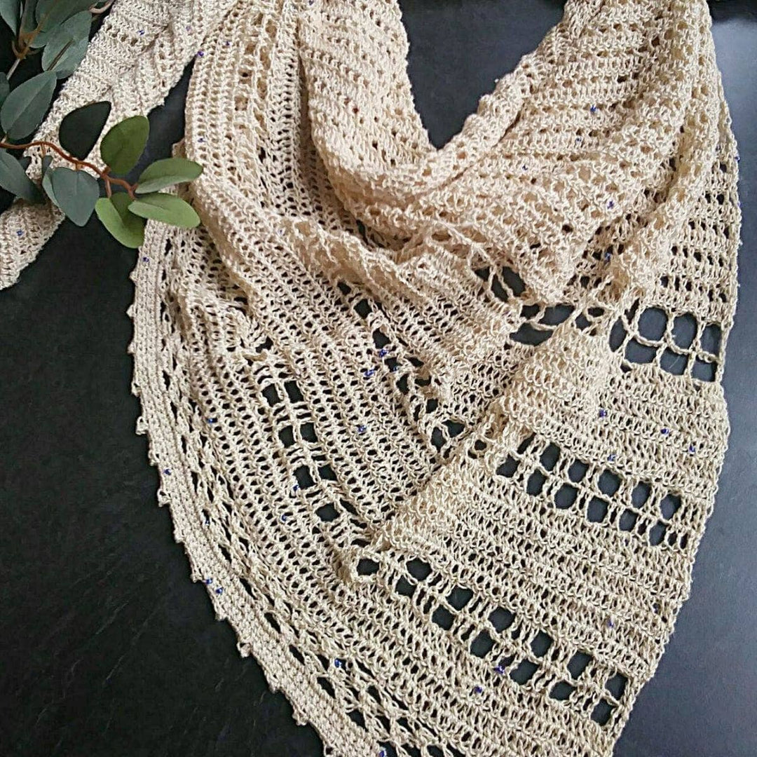 beige shawl over a black table