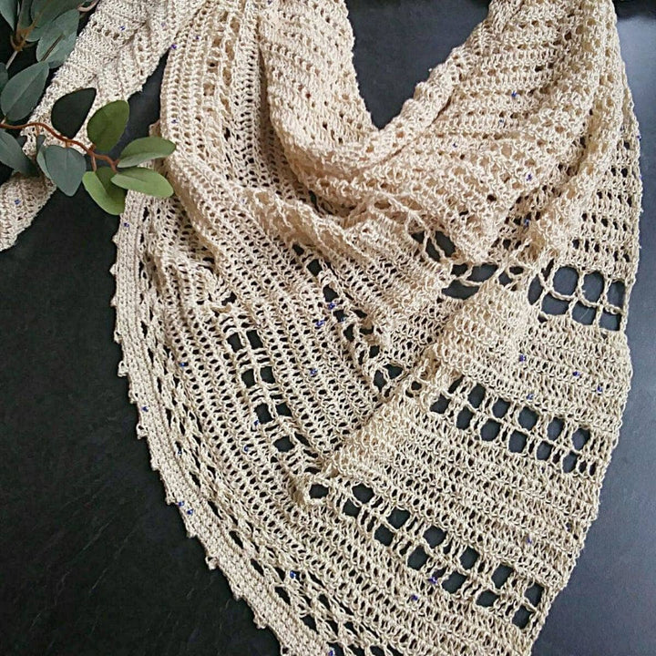 beige shawl over a black table