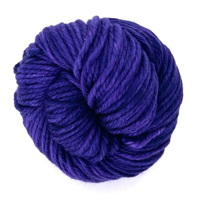 A skein of 100% merino wool Malabrigo chunky yarn in the colorway Violetas.