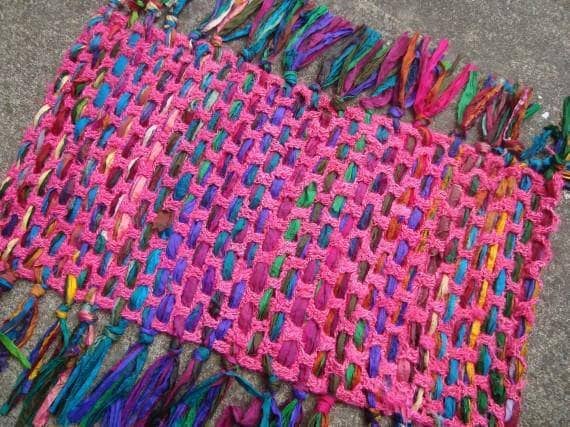 pink yarn mat sitting over the floor