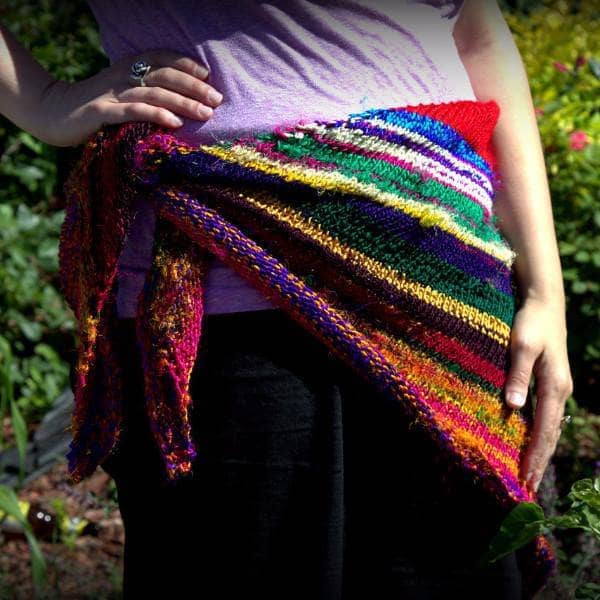 hips of a woman wearing colorful red yellow blue and brown shawl