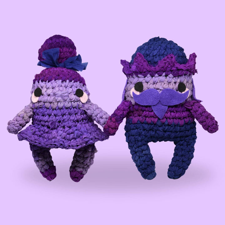 A finished Sugarplum Fairy and Nutcracker Amigurumi made from chiffon ribbon sitting on a purple background.