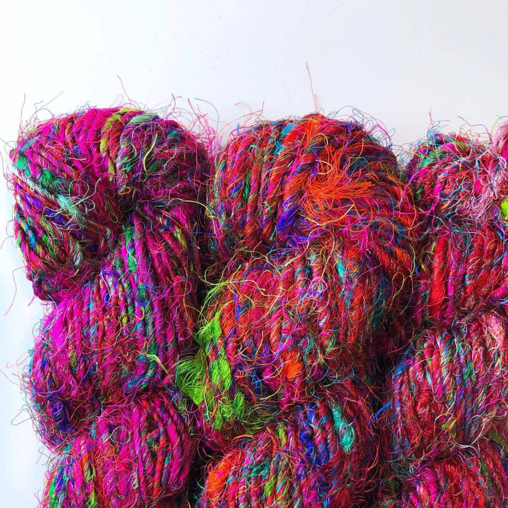 Multicolored skeins of textured yarn with bright fibers.