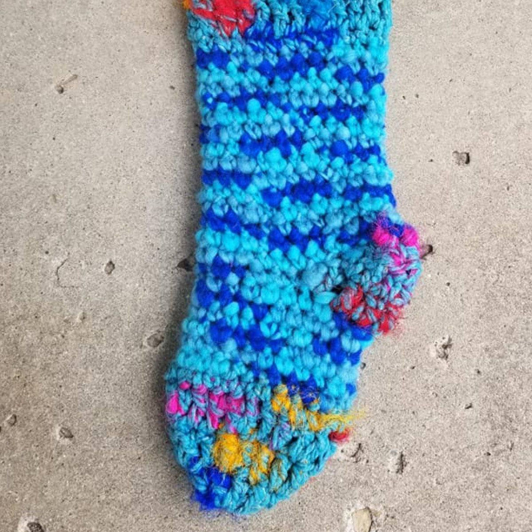 close up of blue holiday Stocking hanging in a wall