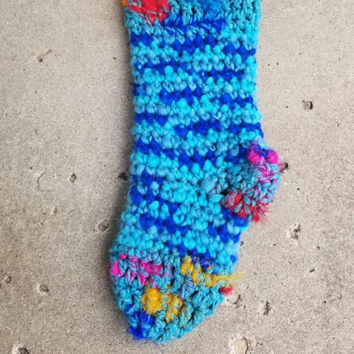 close up of blue holiday Stocking hanging in a wall