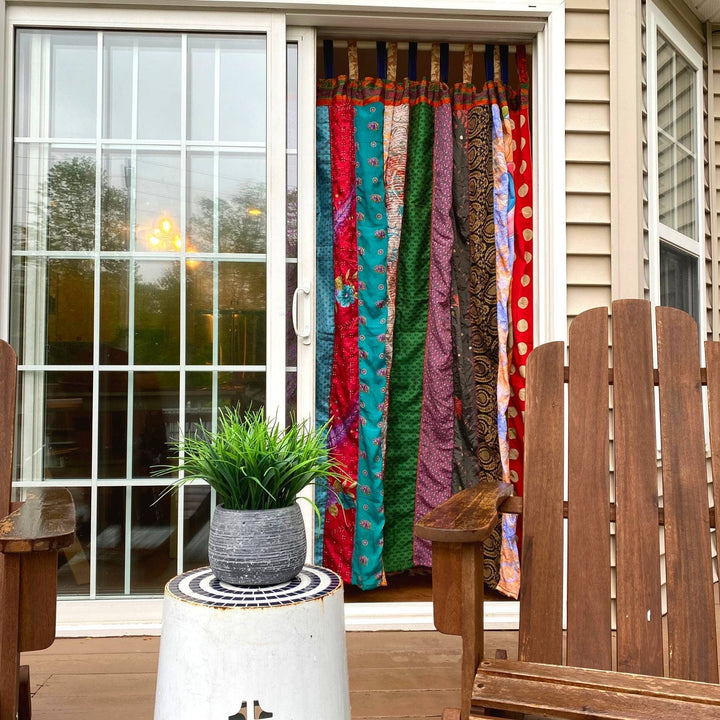 Outside view of patio drapes hanging in the doorway. 