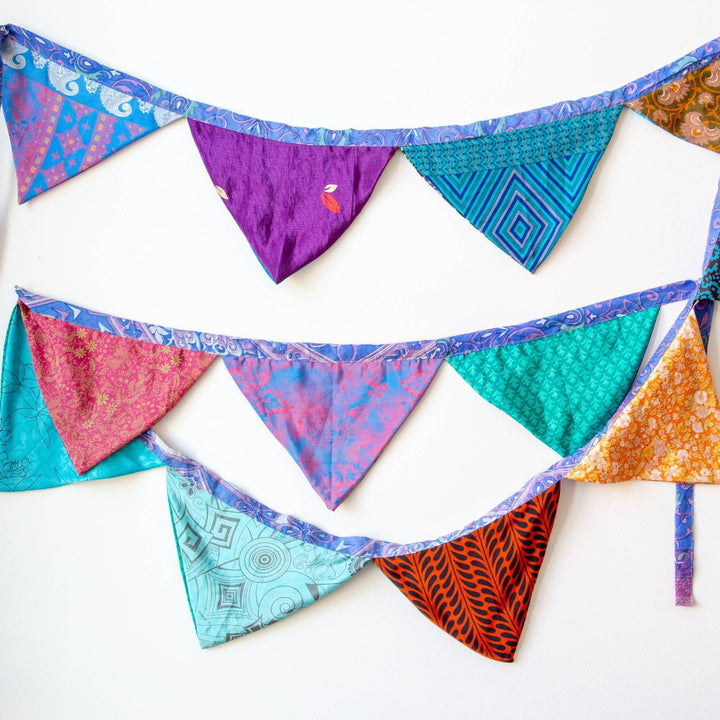 Handmade Recycled Sari Silk Bunting Banner hanging in a white wall