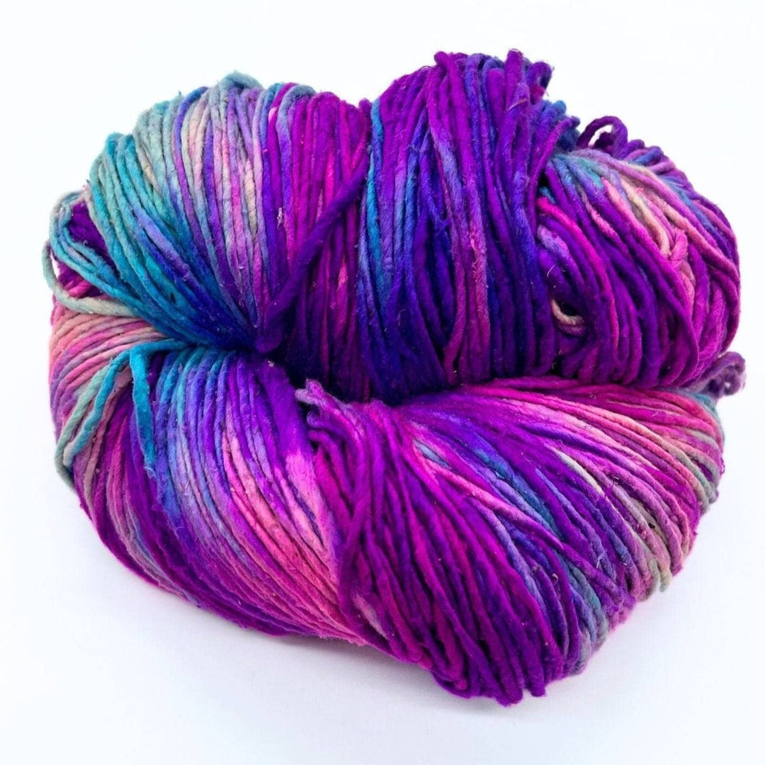 A multicolored yarn twisted into a ball, featuring shades of purple, blue, and pink.