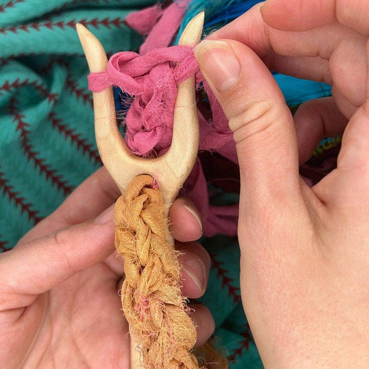 Red maple wooden Lucet being used to make a braided cord