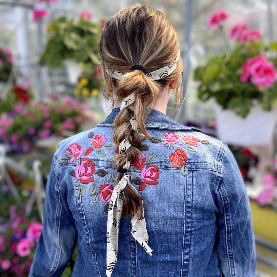 White and black silk head scarf braided into model's hair