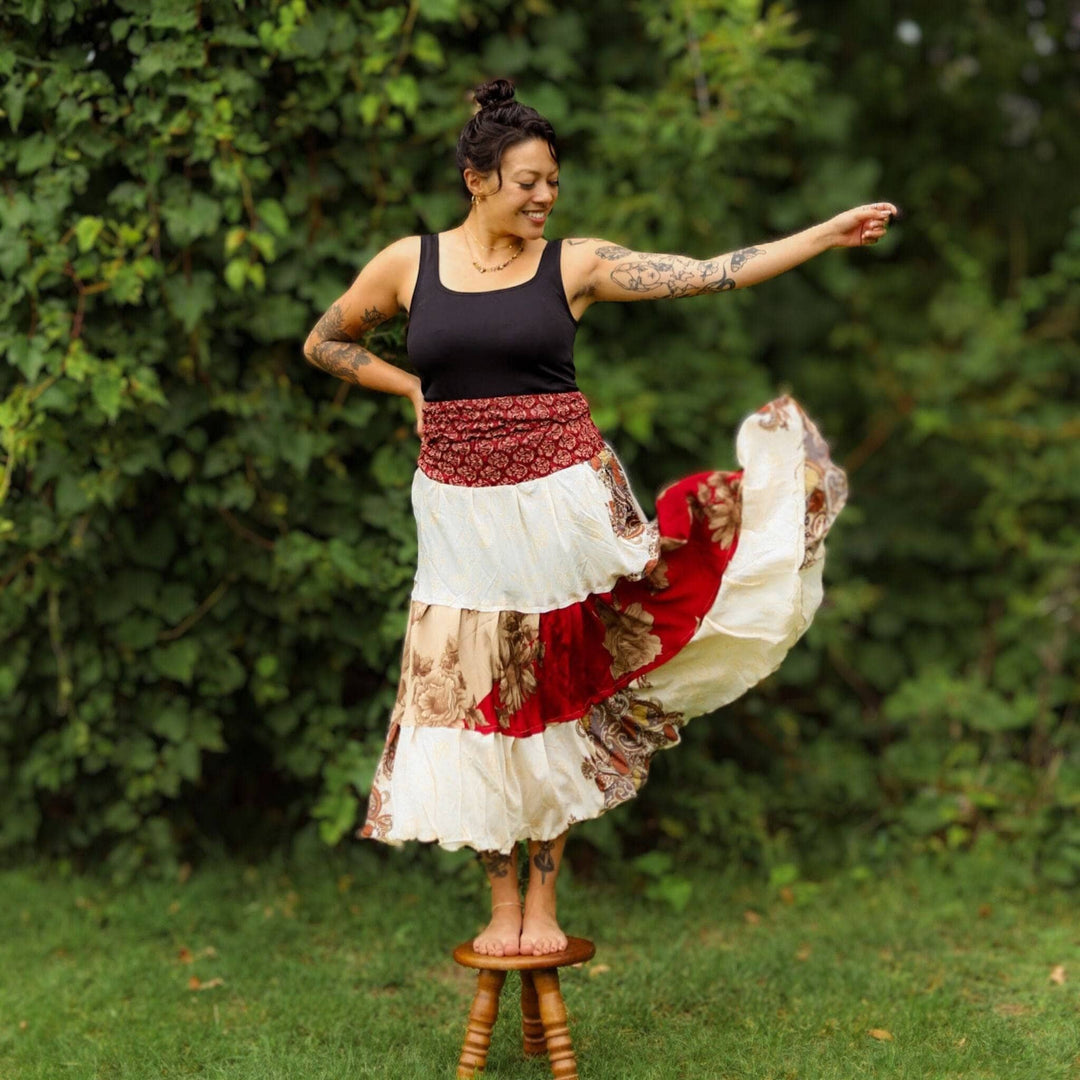 Woman standing on a stool in the forest wears a sedona dress