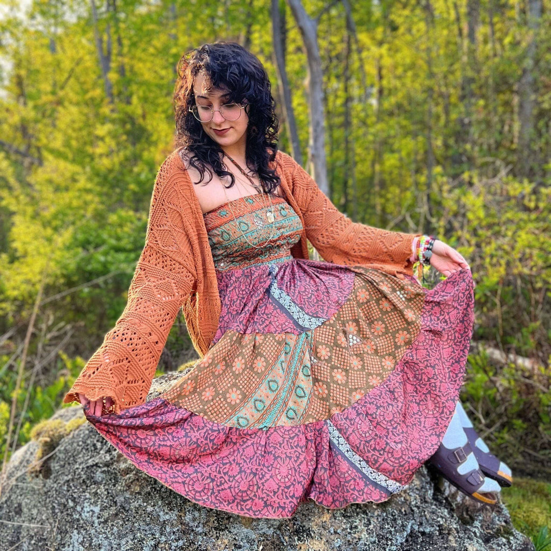 Woman showing the incredible color and patchwork in the dress