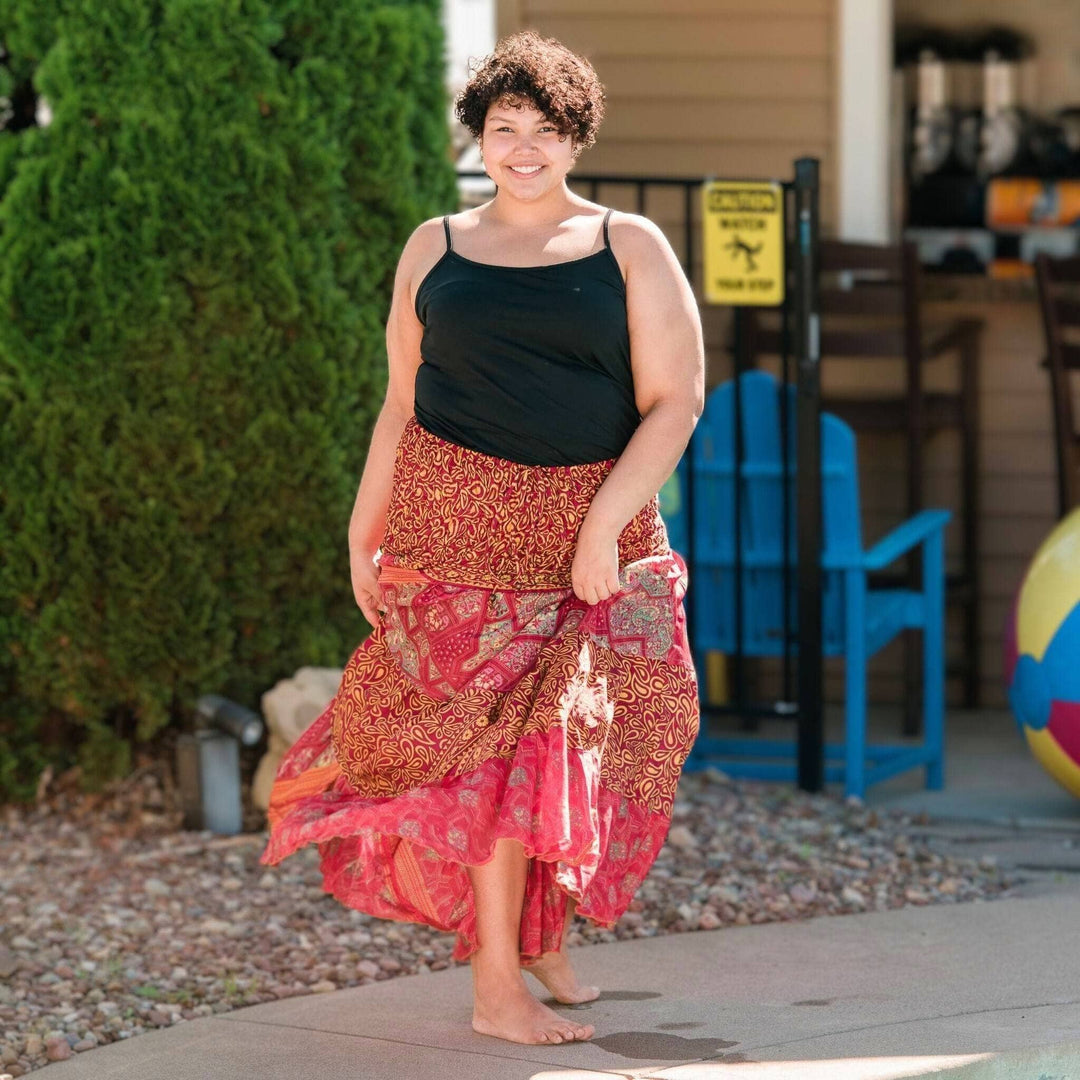 Woman by the pool wearing a reddish sedona dress