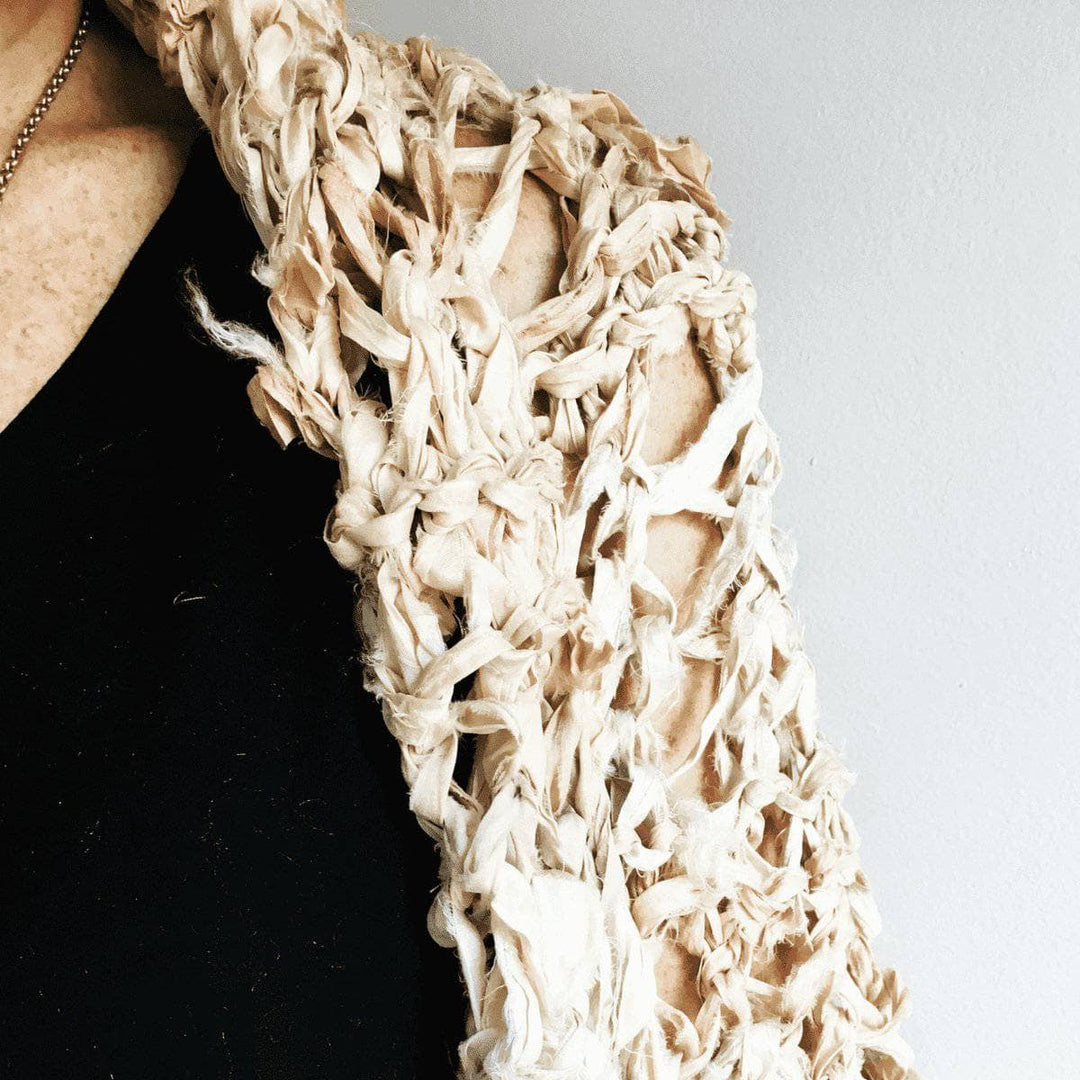 close up of woman wearing a beige Lace Summer Cocoon Coat with a black shirt