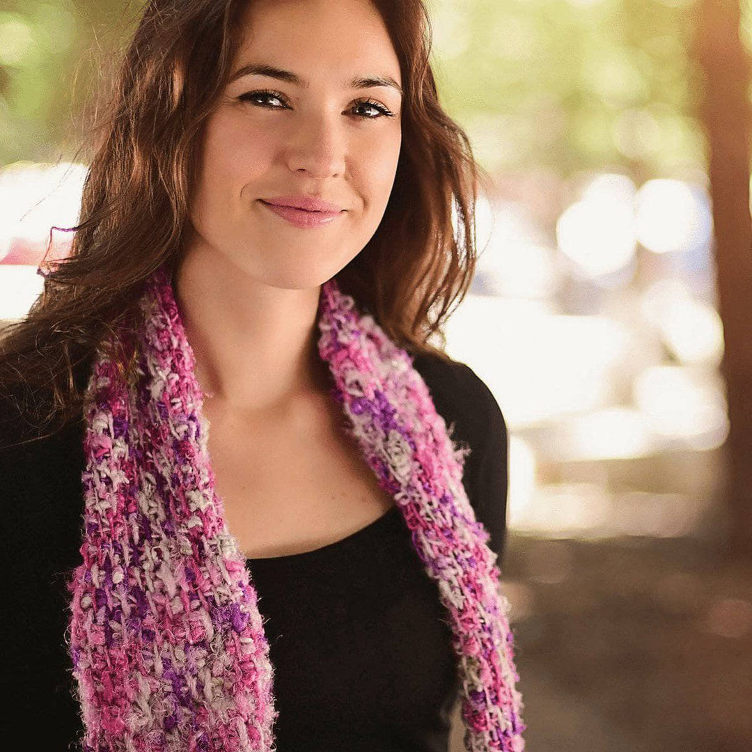 woman wearing a Simple Tunisian Crochet Scarf and smiling outdoors