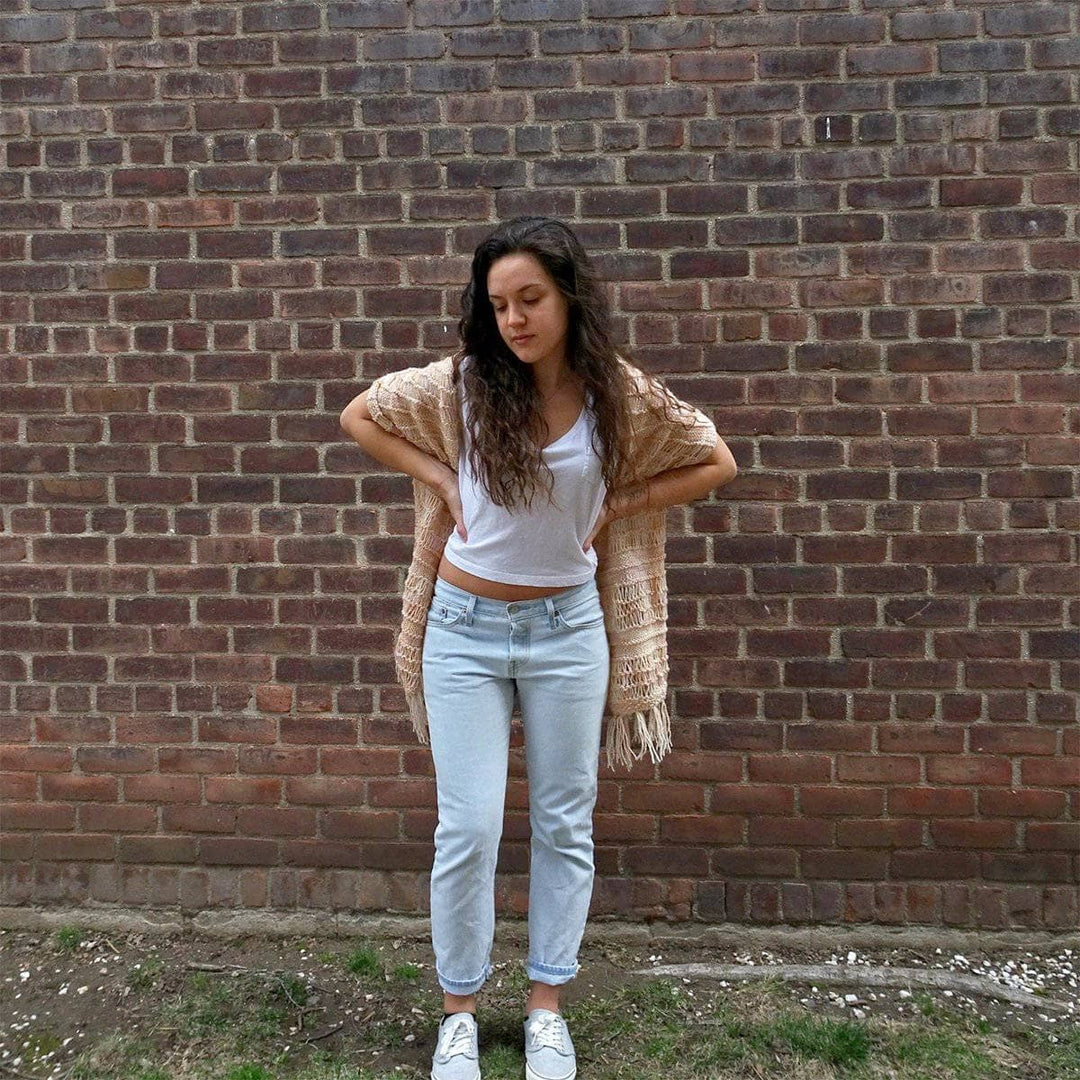 Woman wearing the Spring Vibes Shawl in Samabyon against a brick wall