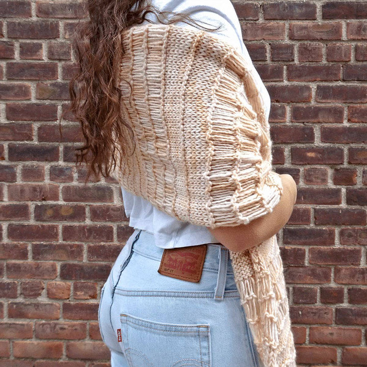 Woman wearing the Spring Vibes Shawl in Samabyon against a brick wall