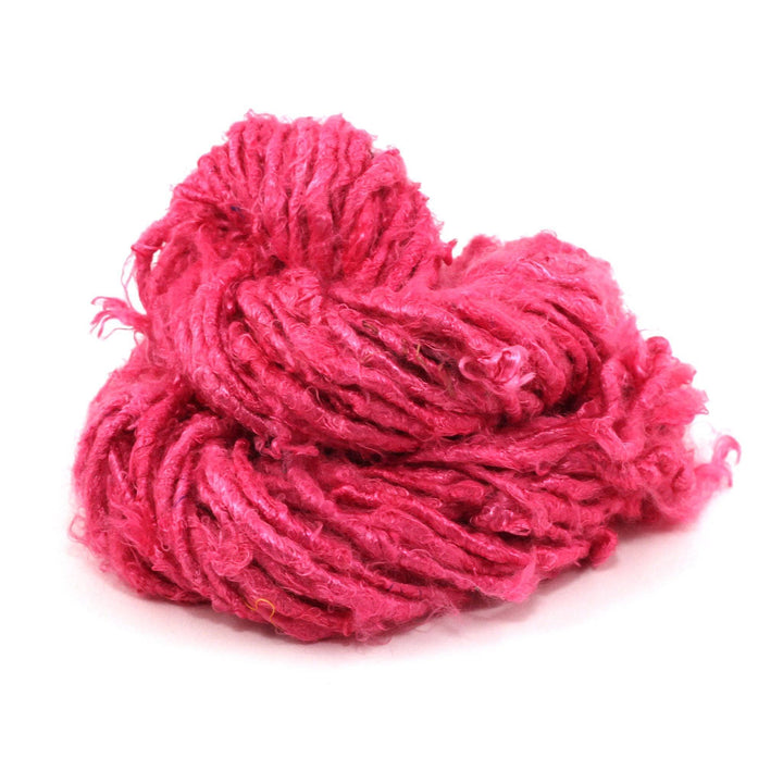 Banana fiber yarn donut ball in Rich Magenta on a white background