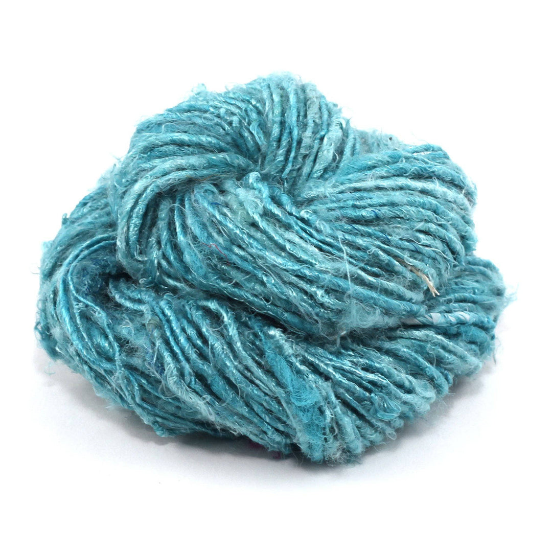 Banana fiber yarn donut ball in Sea Mist (turquoise) on a white background