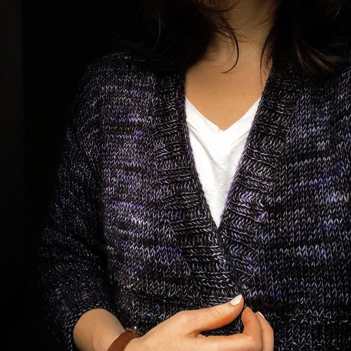 a person wearing a purple cardigan