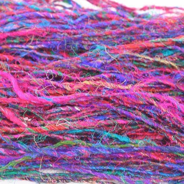 Close up of multicolored Recycled Silk Yarn on a white background