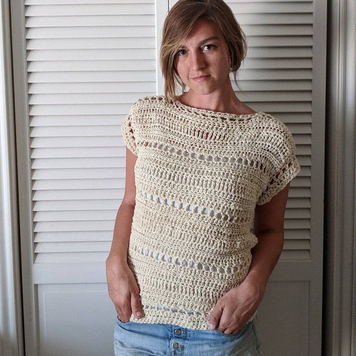 Woman wearing The Driftwood Tee in Dandelion Poof standing against white background